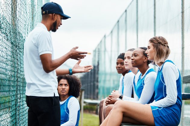 Netball plan, sports team and coach explain game strategy, teamwork collaboration talk or planning competition idea. Coaching athlete, substitute bench and group of people listen to fitness challenge